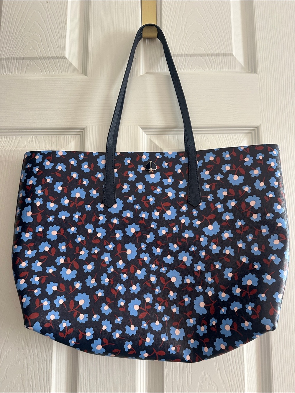Gorgeous Kate Spade navy floral bag w/ light blue and brown accents. Like new.